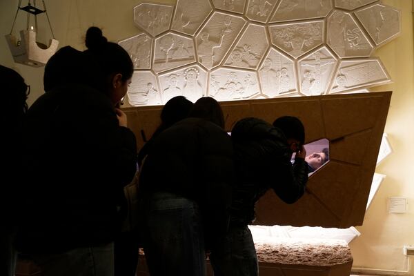 Faithful pay their homage before the tomb of 15-year-old Carlo Acutis, an Italian boy who died in 2006 of leukemia, in Assisi, Italy, on Saturday, March 1, 2025. (AP Photo/Gregorio Borgia)