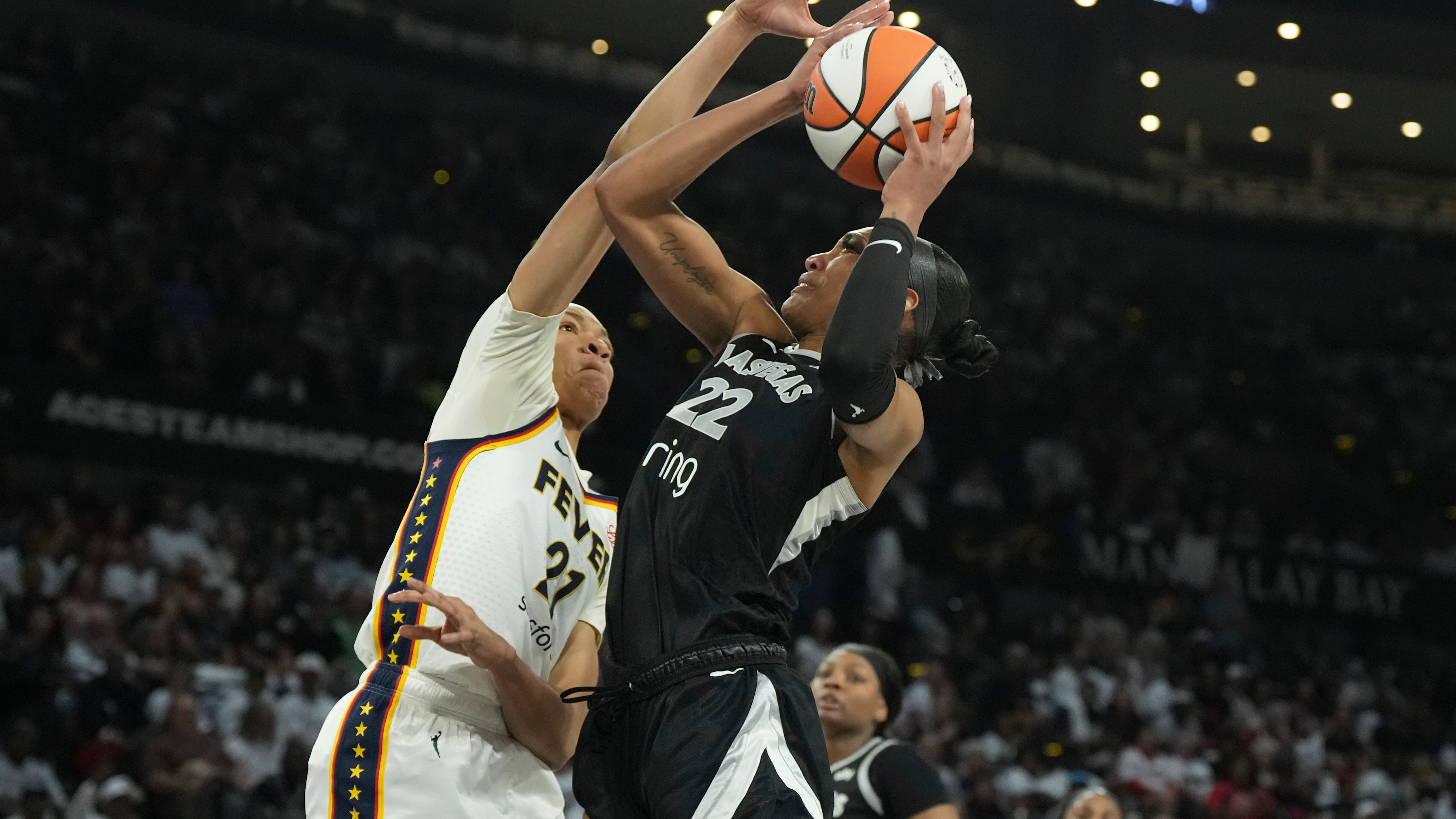 Las Vegas Aces center A'ja Wilson (22) looks to shoot against Indiana Fever forward Makayla Timpson, left, in the first half of Game 1 of a WNBA basketball playoff semifinals series Sunday, Sept. 21, 2025, in Las Vegas. (AP Photo/Candice Ward)