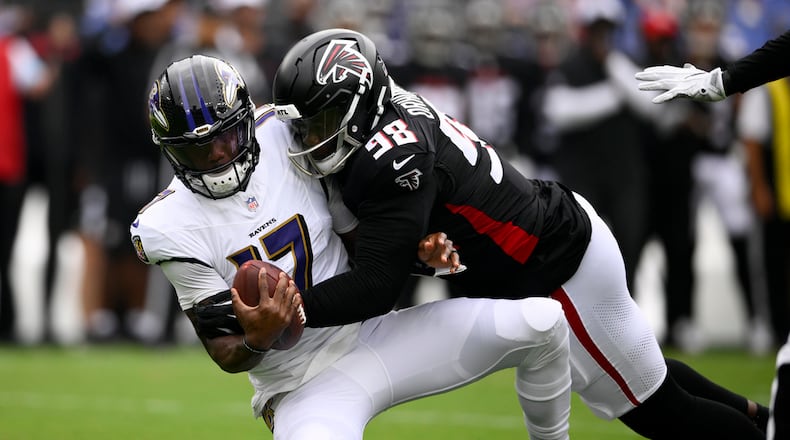 Baltimore Ravens quarterback Josh Johnson is sacked by Atlanta Falcons defensive tackle Ruke Orhorhoro during the first half of a preseason NFL football game on Saturday, Aug. 17, 2024, in Baltimore. (AP Photo/Nick Wass)