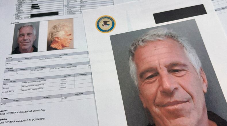 Documents that were included in the U.S. Department of Justice release of the Jeffrey Epstein files are photographed Friday, Jan. 2, 2026. (AP Photo/Jon Elswick)