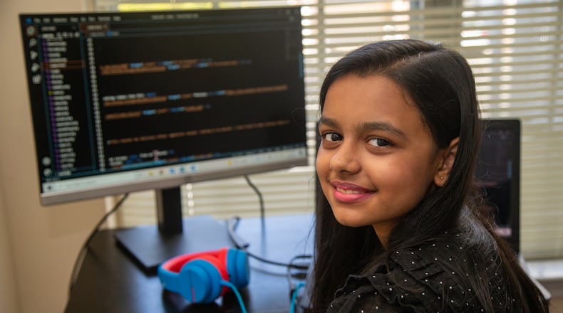 Portrait of Aesha Bhatt at her computer where she taught herself coding in her Johns Creek home. While we've heard a lot of news about kids who lost a year of learning by not being in school, 11-year-old Aesha Bhatt of Johns Creek proves just the opposite, because she's been incredibly creative and productive throughout the pandemic, exploring coding and app development. When the pandemic started, her father Mehul Bhatt wanted his daughter to stay creative and engaged in learning, and while he knew she liked tech, he wasn't sure if coding was right at her age. She took to it immediately. The sixth grader created an anti-bullying app and is helping her mother Hita Bhatt develop a YouTube cooking channel. Aesha designed the channel's website and logo and edits its pages.
PHIL SKINNER FOR THE ATLANTA JOURNAL-CONSTITUTION.
