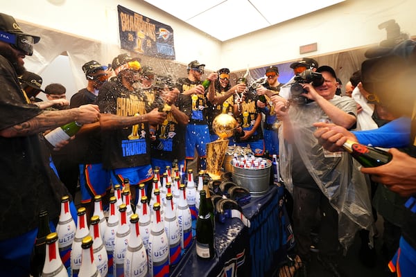 Oklahoma City Thunder players celebrate in the locker room after winning the NBA basketball championship with a Game 7 victory against the Indiana Pacers Sunday, June 22, 2025, in Oklahoma City. (AP Photo/Julio Cortez)
