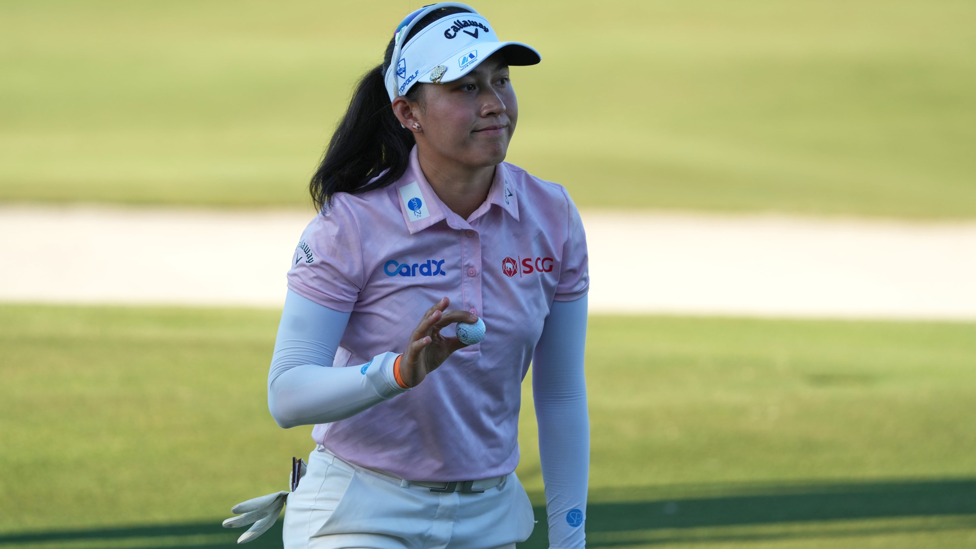 Jeeno Thitikul of Thailand shows her ball after making a birdie putt on the 17th hole during the second round of the LPGA Tour Championship golf tournament, Friday, Nov. 21, 2025, in Naples, Fla. (AP Photo/Marta Lavandier)