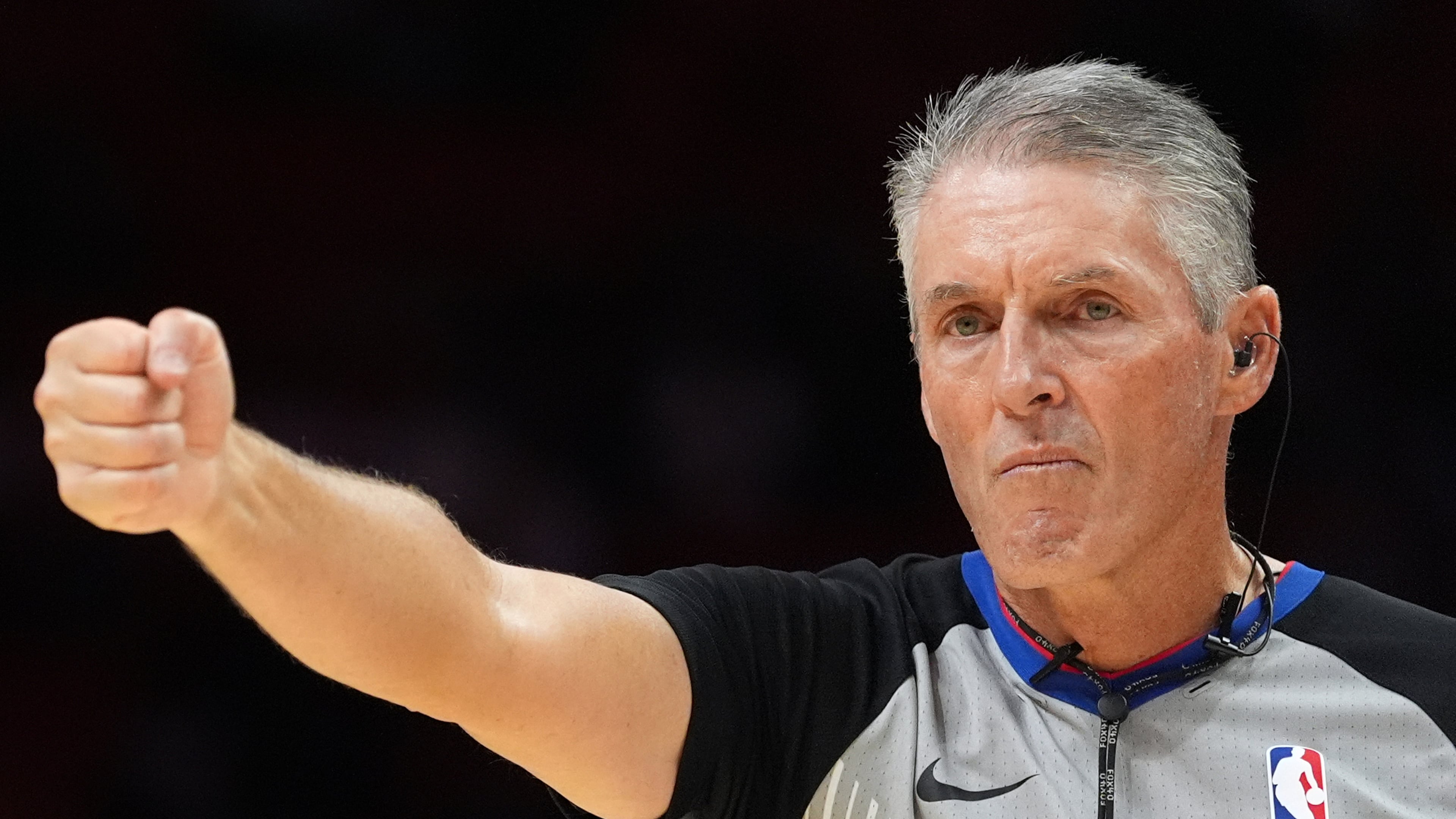 Referee Scott Foster, wearing an earpiece, signals a call during the second half of a preseason NBA basketball game between the Miami Heat and the Milwaukee Bucks, Monday, Oct. 6, 2025, in Miami. (AP Photo/Rebecca Blackwell)