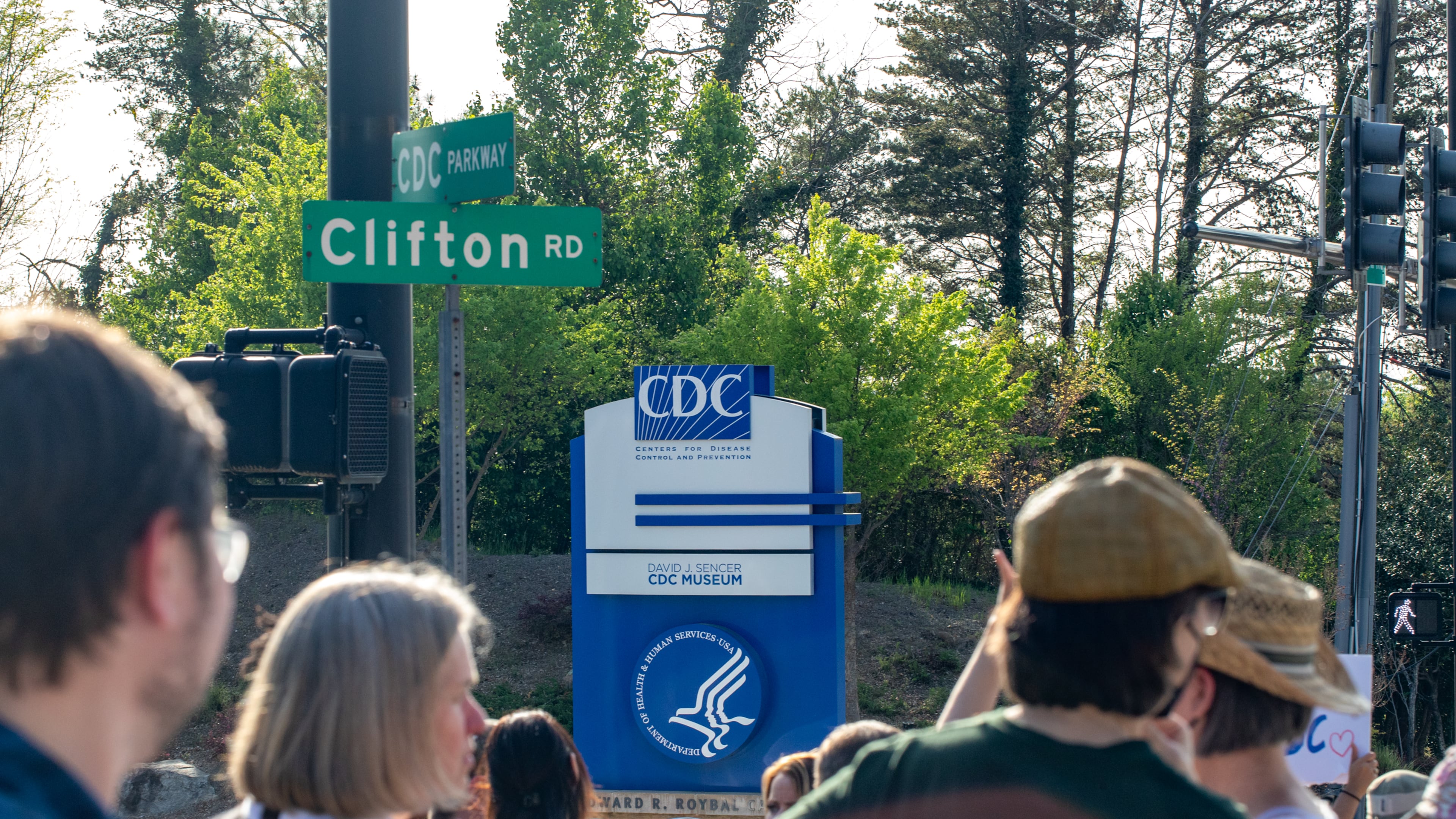 Supporters gather at the intersection of Clifton and CDC Parkway after federal cuts triggered significant layoffs, April 1, 2025 at the Centers for Disease Control and Prevention. (Jenni Girtman for the AJC)