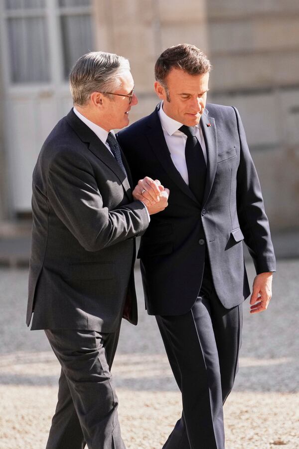 French President Emmanuel Macron, right, greets Britain's Prime Minister Keir Starmer during arrivals for a summit on Ukraine at the Elysee Palace in Paris, Thursday, March 27, 2025 . (AP Photo/Thibault Camus)