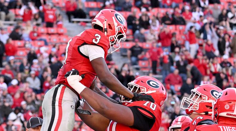 Georgia running back Nate Frazier (3) celebrates with Georgia offensive lineman Daniel Calhoun (70) after scoring a touchdown during the second half in an NCAA football game at Sanford Stadium, Saturday, November 23, 2024, in Athens. Georgia won 59-21 over UMass. (Hyosub Shin / AJC)