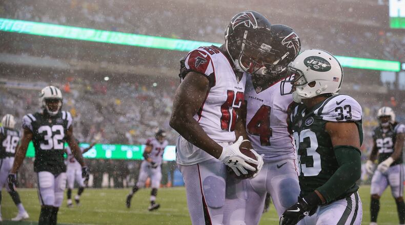 Falcons wide receiver Mohamed Sanu celebrates his celebrates his touchdown with teammate Justin Hardy against New York Jets strong safety Jamal Adams during the fourth quarter Sunday.