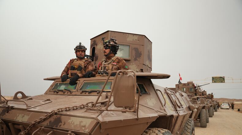 Iraqi Border Guards patrol in armored vehicles along the border with Syria, in Sinjar, northern Iraq, Thursday, Jan. 22, 2026. (AP Photo/Farid Abdulwahed)