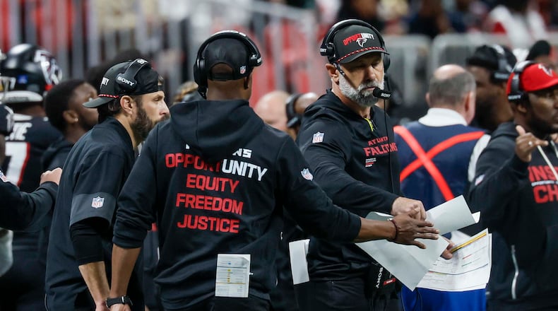 Falcons defensive coordinator Jeff Ulbrich (right) fist-bumps head coach Raheem Morris after a play during the second half against the Saints on Jan. 4, 2026. (Miguel Martinez/ AJC)