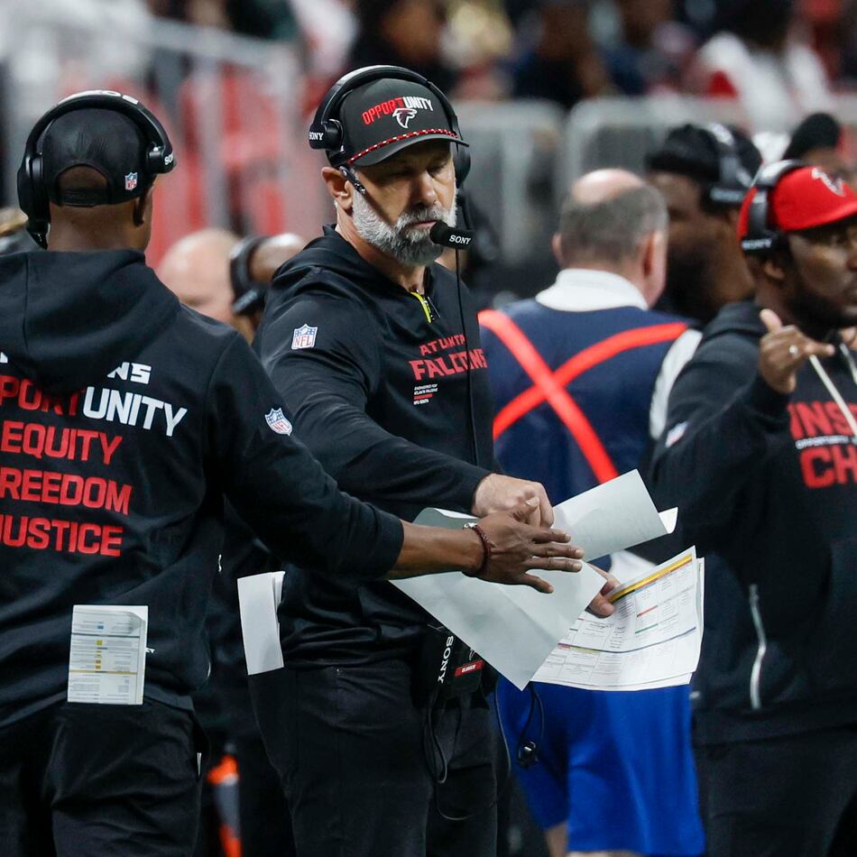 Falcons defensive coordinator Jeff Ulbrich (right) fist-bumps head coach Raheem Morris after a play during the second half against the Saints on Jan. 4, 2026. (Miguel Martinez/ AJC)