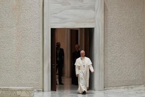 Pope Leo XIV arrives as he meets members of the international media in the Paul VI Hall at the Vatican, Tuesday, May 13, 2025. (AP Photo/Domenico Stinellis)