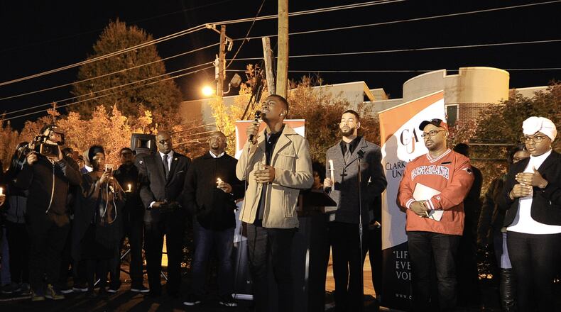 Clark Atlanta University student Kwesi Williams leads a crowd of supporters from the university and the Atlanta University Center community in song during a candlelight vigil in memory of Alexis Crawford on Nov. 10. Student Government Association President Levon Campbell Jr. is dressed in gray, standing to the right of Williams.