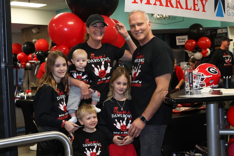Former UGA football coach Mark Richt poses for a photo with his wife Katharyn and four of their grandchildren during the third annual Chick-fil-A Dawg Bowl fundraiser for Parkinson’s and Crohn’s disease research at Showtime Bowl in Athens on Wednesday, Oct. 22, 2025. Richt, who was diagnosed with Parkinson’s disease in 2021, hosted the event. (C.J. Bartunek for the AJC)