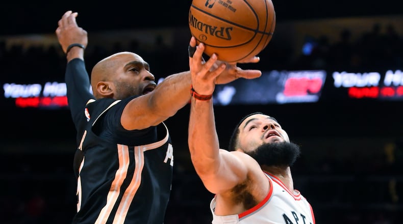 Hawks guard Vince Carter blocks a shot by Raptors guard Fred VanVleet during the second half Monday, Jan. 20, 2020, at State Farm Arena in Atlanta. Toronto won 122-117.
