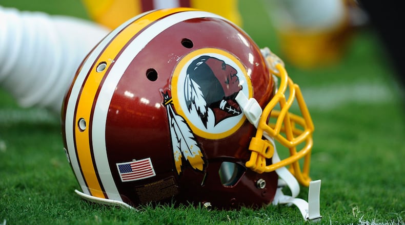 A Washington Redskins helmet sits on the grass during a preseason football game between the Redskins and Cleveland Browns at FedExField on August 18, 2014 in Landover, Maryland.  (Photo by TJ Root/Getty Images)