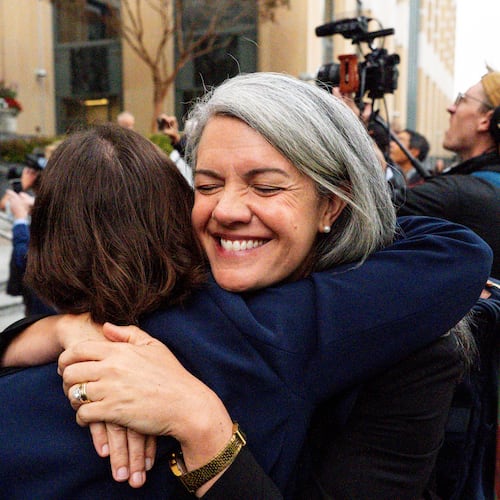 Colorado Solicitor General Shannon Stevenson, right, hugs a colleague outside of court after tech giant Meta agreed to pay $17 billion as part of a settlement to end a landmark trial over teen social media addiction in Oakland, Wednesday, Aug. 26, 2026. (AP Photo/Noah Berger)
