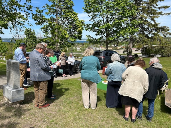 People gather at Greenwood Cemetery for the burial of Larry Rubin, former executive secretary of the Mackinac Bridge Authority, in Petoskey, Mich., Wednesday May 28, 2025. (Daniel Zivian via AP)