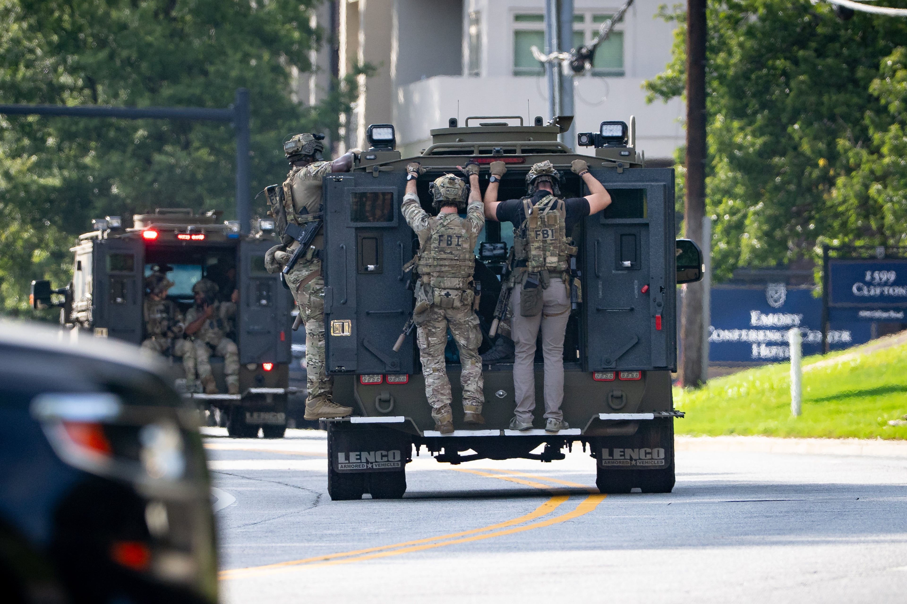 The FBI Atlanta SWAT team arrives at the scene of the shooting near a building at the Atlanta-based headquarters of the Centers for Disease Control and Prevention on Friday, August 8, 2025. (Ben Hendren for The Atlanta Journal-Constitution)