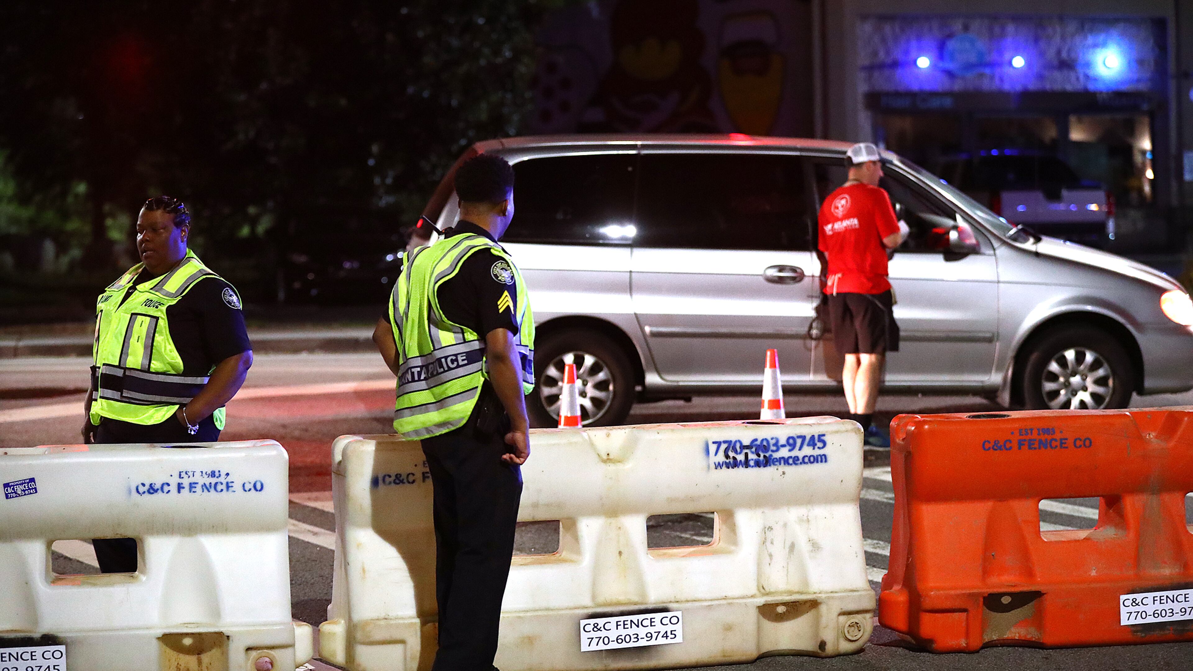 Atlanta police officers man a barricade at 10th Street and Monroe Drive N.E. as roads are shut down for the AJC Peachtree Road Race. (File/AJC 2019)