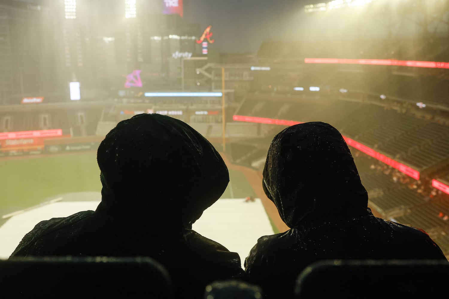 Fans overlook the stadium during a rain delay before the first inning of the Braves versus Philadelphia Phillies game at Truist Park in Atlanta on Friday, June 27, 2025. (Abbey Cutrer / AJC)
