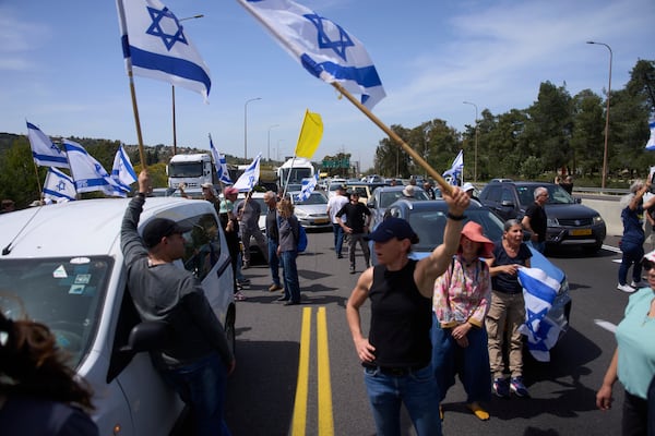 Israelis block a highway between Jerusalem and Tel Aviv in a protest against Prime Minister Benjamin Netanyahu's government, demanding the realese of the hostages held by Hamas in the Gaza Strip, Wednesday, March 26, 2025. (AP Photo/Ohad Zwigenberg)