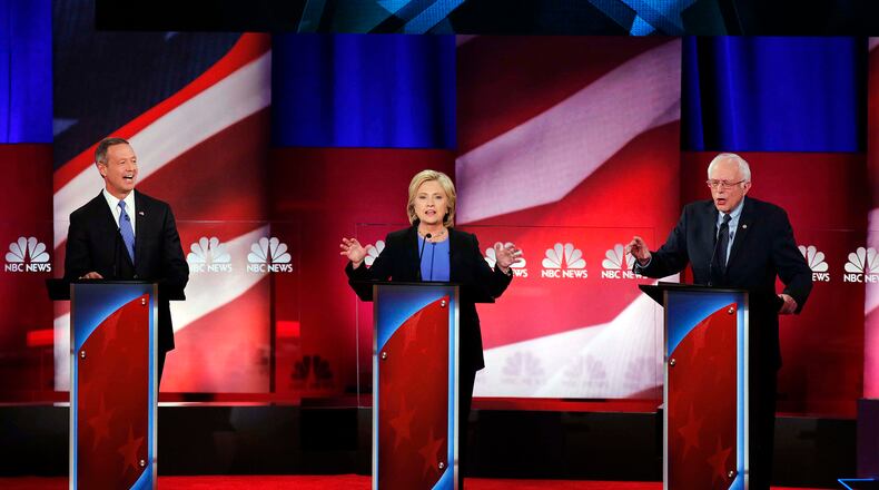 DEMOCRATIC DEBATE--Democratic presidential candidate, Hillary Clinton, center, Democratic presidential candidate, Sen. Bernie Sanders, I-Vt. left, and Democratic presidential candidate, former Maryland Gov. Martin O'Malley, right, seems to speaks at the same time, during the NBC, YouTube Democratic presidential debate at the Gaillard Center, Sunday, Jan. 17, 2016, in Charleston, S.C. (AP Photo/Mic Smith)