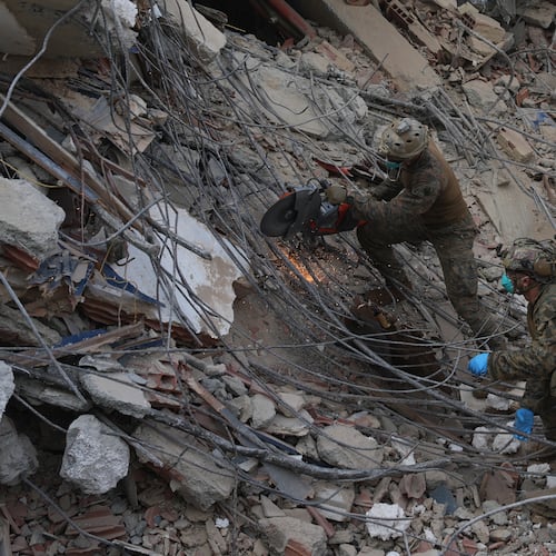 U.S. troops cut through rebar while clearing rubble during a search at a building that collapsed in the twin earthquakes in La Guaira, Venezuela, Tuesday, June 30, 2026. (AP Photo/Ariana Cubillos)