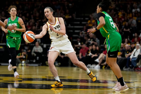 Indiana Fever guard Caitlin Clark, center, passes upcourt during the second half of an exhibition women's basketball game against Brazil, Sunday, May 4, 2025, in Iowa City, Iowa. (AP Photo/Charlie Neibergall)