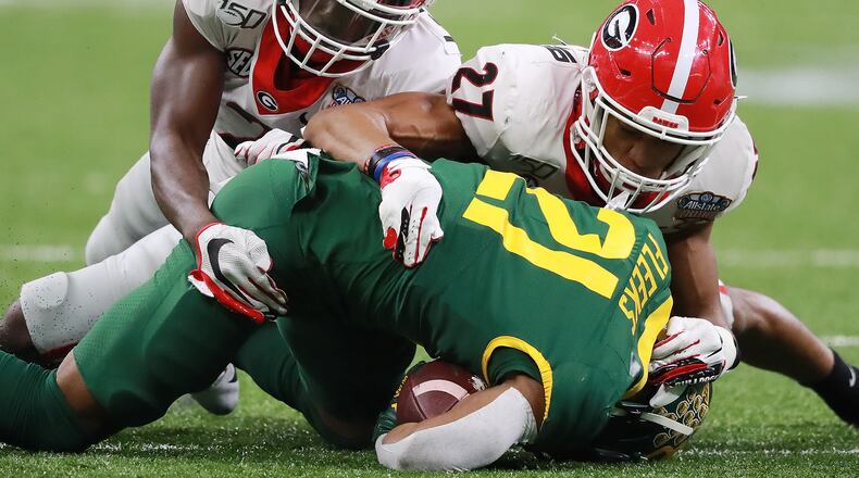 January 1, 2020 New Orleans: Georgia defensive backs Richard LeCounte (left) and Eric Stokes (right) team up to take down Baylor's Josh Fleeks during the Sugar Bowl on January 1, 2020, in New Orleans. Both players are on several 'watch lists' to earn national awards this season. Curtis Compton ccompton@ajc.com