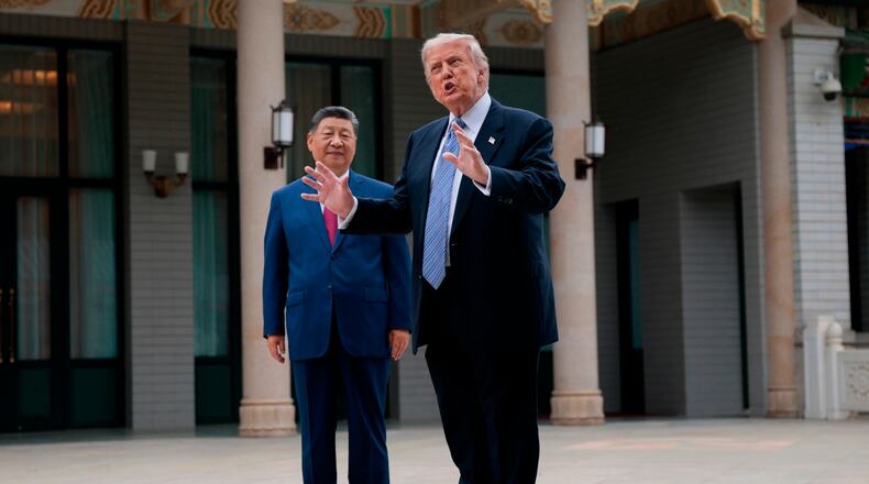U.S. President Donald Trump, right, gestures as he speaks next to Chinese President Xi Jinping during a visit to the Zhongnanhai Garden in Beijing, China, Friday, May 15, 2026. (Evan Vucci/Pool Photo via AP)