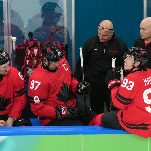 Canada's Sidney Crosby (87) is attended to after being injured during the second period of a men's ice hockey quarterfinal game between Canada and Czechia at the 2026 Winter Olympics, in Milan, Italy, Wednesday, Feb. 18, 2026. (AP Photo/Hassan Ammar)