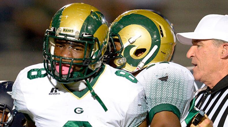 Emotions run high as Grayson's Mohamed Barry (8) is held back from South Gwinnett's Anthony Pittman (62) and Trevon Vallery (18) in the first half of their high school football game on Friday, Oct. 18, 2013, in Snellville, Ga. David Tulis / AJC Special