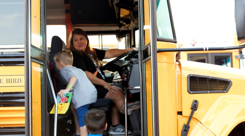 A Cobb County School District bus driver picks up students at Picketts Mill Elementary School.