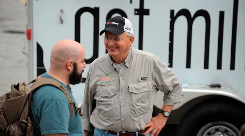 Georgia Agriculture Commissioner Gary Black, right, talks with Pete Chagnon of New Life FM radio at the Georgia Grown Farmers Showcase which features agricultural products from all corners of Georgia coming together under one shed for one day on Saturday, July 27, 2013, at the Atlanta State Farmers Market. David Tulis / AJC Special