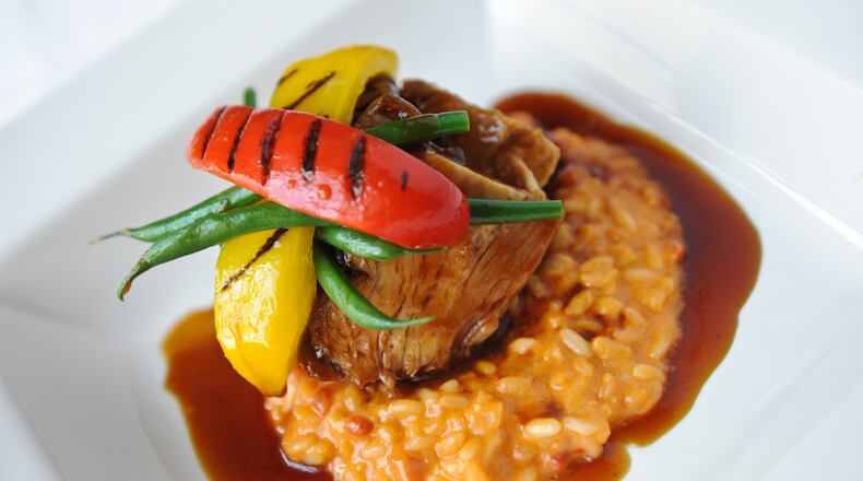Slow Braised Niman Ranch Berkshire Pork Shoulder- pimento cheese risotto, roasted sweet peppers, Vidalia onion & bacon marmalade from Aria's menu. / AJC file photo