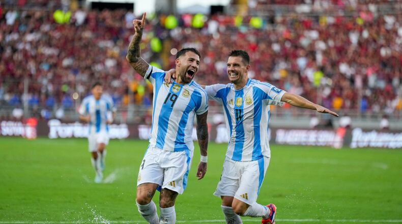 FILE - Argentina's Nicolas Otamendi (19, File) celebrates with Giovani Lo Celso after scoring his side's opening goal against Venezuela during a FIFA World Cup 2026 qualifying soccer match in Maturin, Venezuela, Thursday, Oct. 10, 2024. (AP Photo/Ariana Cubillos, File)