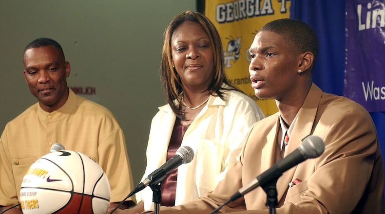 Georgia Tech freshman Chris Bosh, right, speaks during a news conference, Friday, May 9, 2003, as his father Noel, left, and mother Freida, center, look on, in Dallas. Bosh said he was entering the NBA draft. (Photo Credit/ TONY GUTIERREZ)