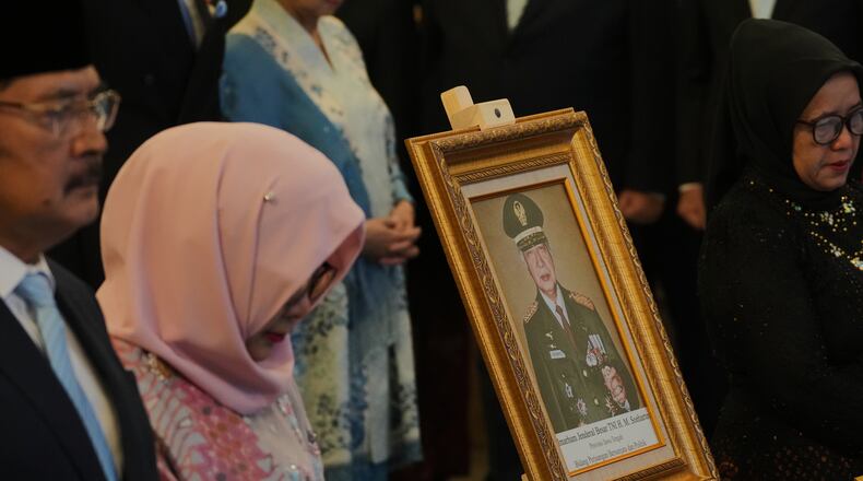 A portrait of the late President Suharto is displayed during a ceremony awarding national hero title to ten figures including the former strongman, at the State Palace in Jakarta, Indonesia, Monday, Nov. 10, 2025. (AP Photo/Achmad Ibrahim)