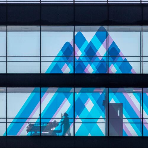 FILE - A medical worker transports a patient at Mount Sinai Hospital, April 1, 2020, in New York. (AP Photo/Mary Altaffer, File)