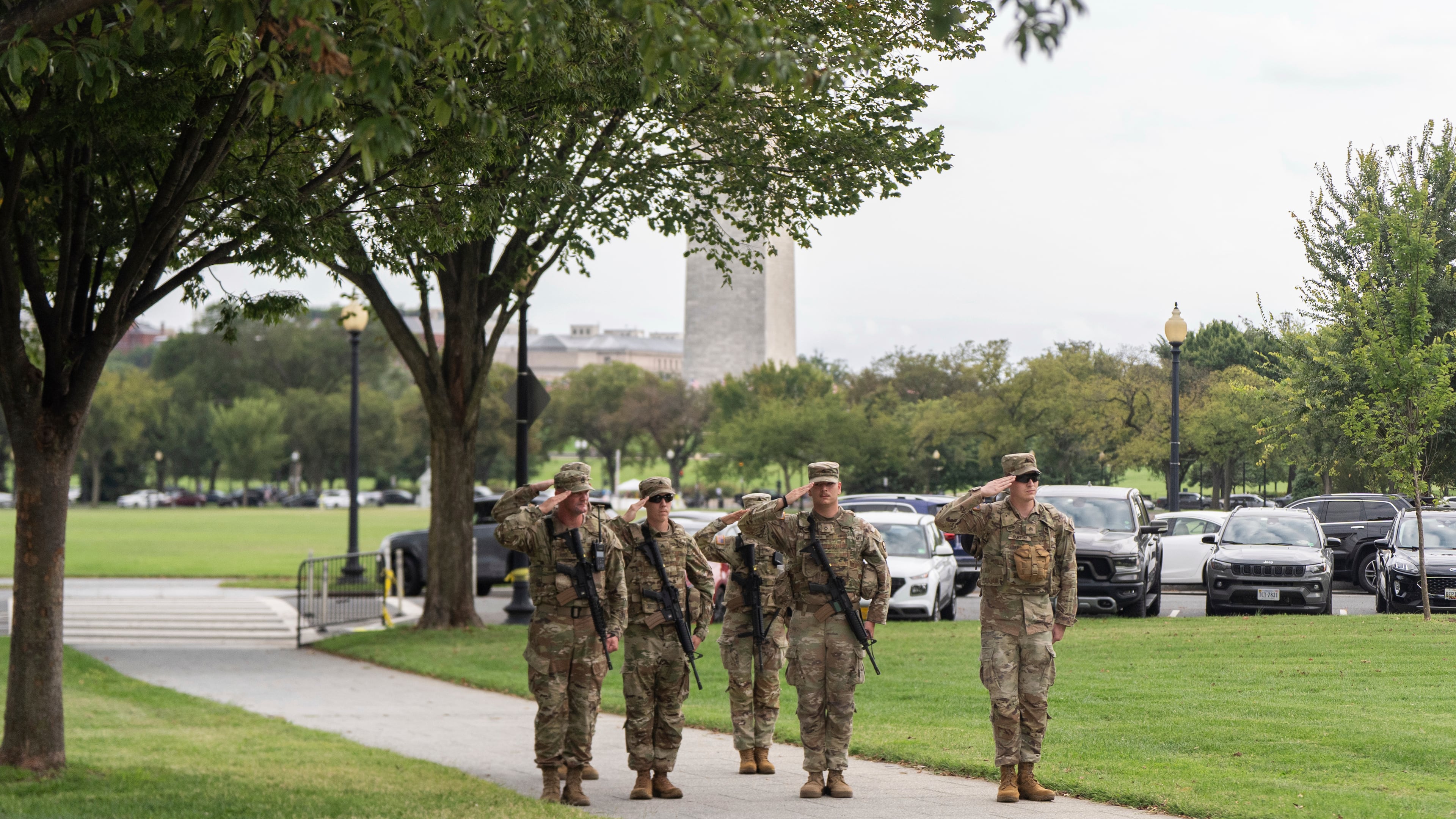 National Guard soldiers salute as President Donald Trump's motorcade drives by, Saturday, Sept. 20, 2025, in Washington. (AP Photo/Julia Demaree Nikhinson)