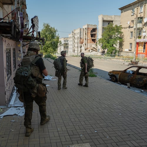 In this photo provided by Ukraine's 93rd Kholodnyi Yar Separate Mechanized Brigade press service and taken Monday, Aug. 10, 2026, Ukrainian soldiers walk along the street in the frontline town of Druzhkivka, Donetsk region, Ukraine. (Iryna Rybakova/Ukraine's 93rd Mechanized Brigade via AP))