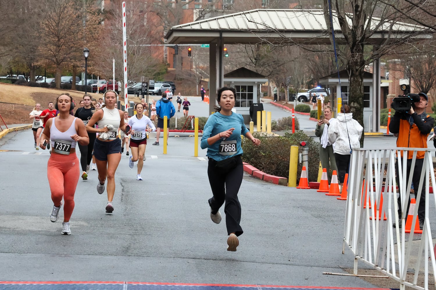 Runners near the finish line on Saturday, Feb. 21, 2026, at a 5K walk/run and memorial service at UGA for Augusta University nursing student Laken Riley. Riley was attacked on Feb. 22, 2024 while running in Oconee Forest Park on the UGA campus and killed. Riley had previously attended UGA and was an avid runner. (C.J. Bartunek for the AJC)

