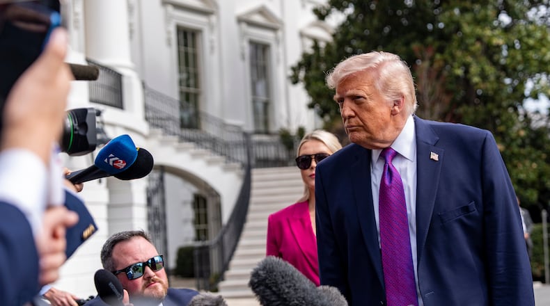 President Donald Trump speaks with reporters before departing on Marine One from the South Lawn of the White House, Wednesday, March 11, 2026, in Washington. (AP Photo/Alex Brandon)