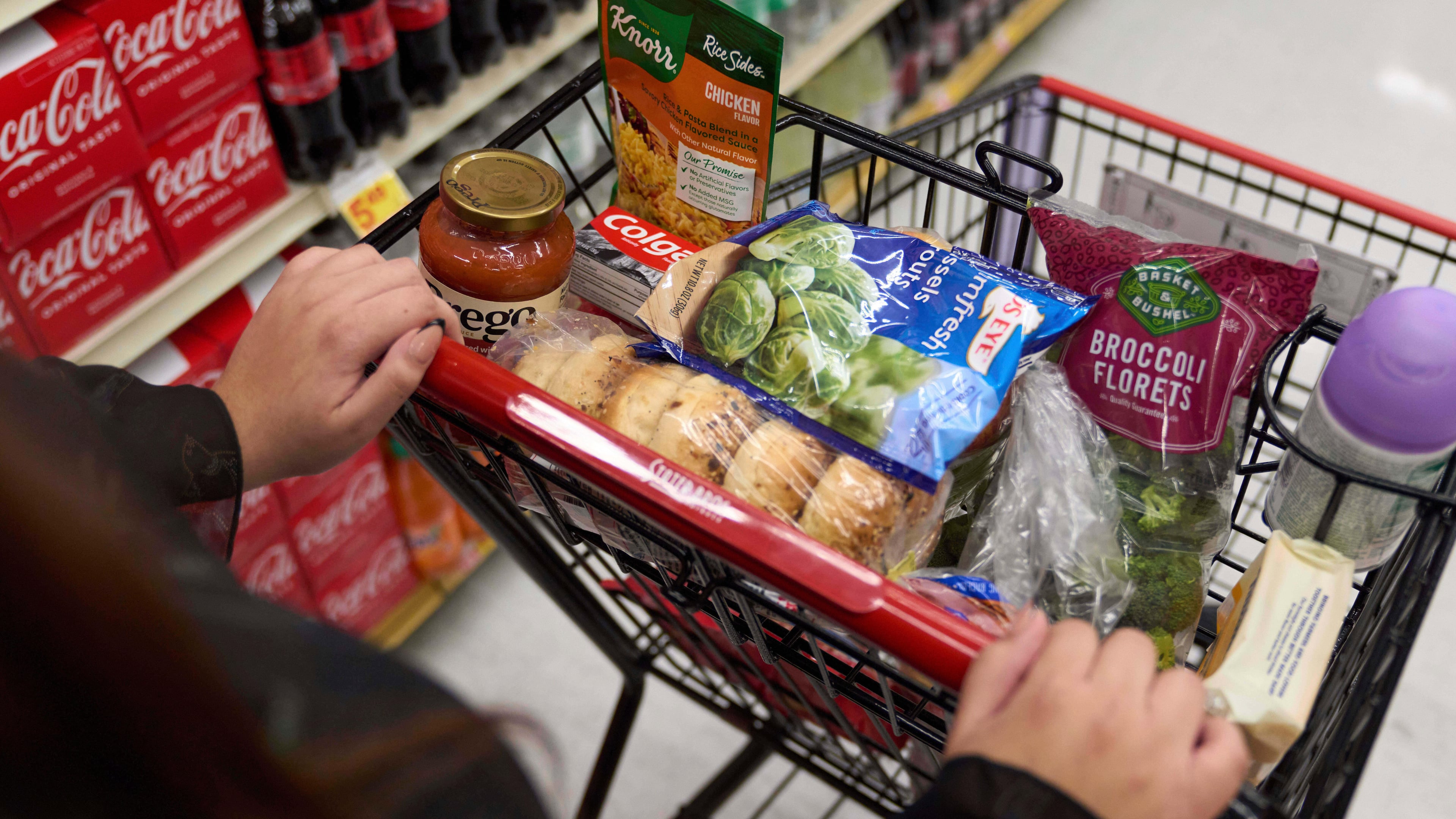 FILE - A California's SNAP benefits shopper pushes a cart through a supermarket in Bellflower, Calif., Feb. 13, 2023. (AP Photo/Allison Dinner, File)