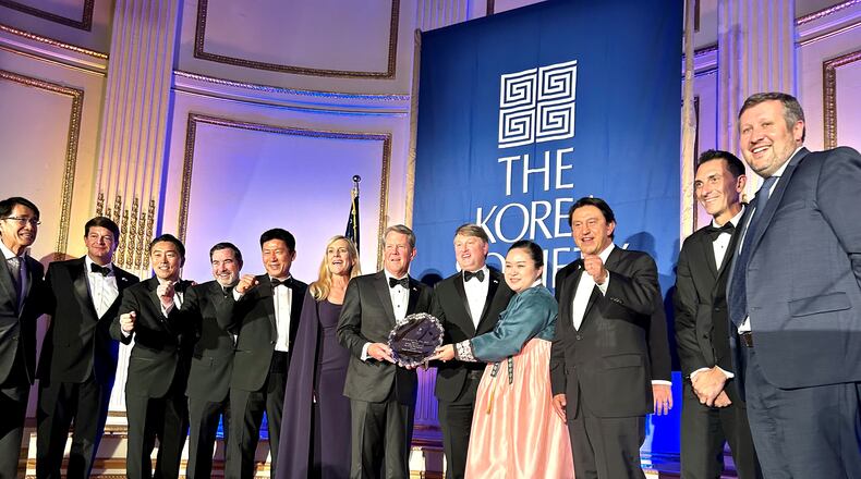 Gov. Brian Kemp, center, is joined by officials from the state, Hyundai Motor Group and other business and diplomatic officials at the annual Korea Society dinner. The state was honored with the Gen. James A. Van Fleet Award for its economic alliance with Korea. (J. Scott Trubey/AJC)