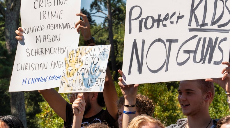 Students who walked out of their schools Friday hold up signs during a rally at J.B. Williams Park on Sept. 20, 2024. (Olivia Bowdoin for the AJC)