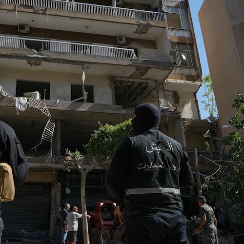 Members of the Lebanese Army Intelligence stand guard in front of an apartment that was struck in an Israeli airstrike in Dahiyeh, Beirut's southern suburbs, Lebanon, Sunday, June 14, 2026. (AP Photo/Bilal Hussein)