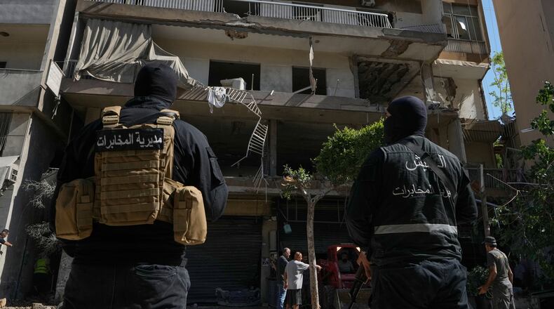 Members of the Lebanese Army Intelligence stand guard in front of an apartment that was struck in an Israeli airstrike in Dahiyeh, Beirut's southern suburbs, Lebanon, Sunday, June 14, 2026. (AP Photo/Bilal Hussein)