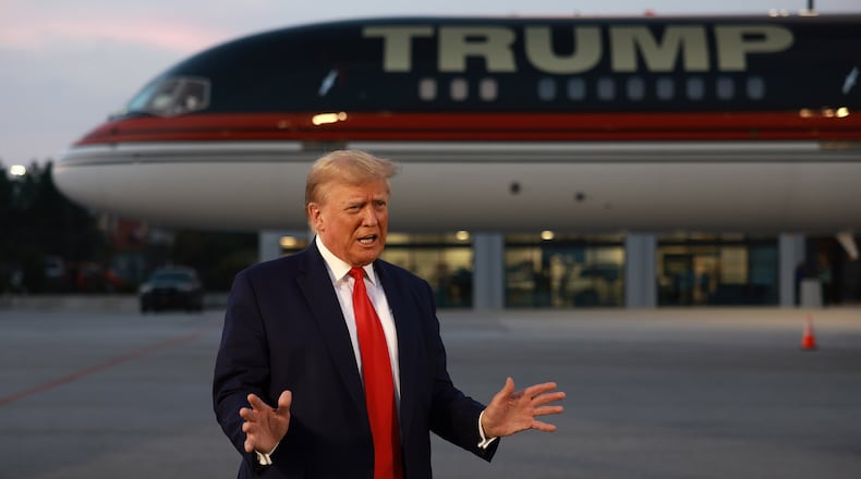 Former President Donald Trump speaks to the media at Atlanta Hartsfield-Jackson International Airport after surrendering at the Fulton County jail on Thursday, Aug. 24, 2023, in Atlanta. Trump was booked on multiple charges related to an alleged plan to overturn the results of the 2020 presidential election in Georgia. (Joe Raedle/Getty Images/TNS)